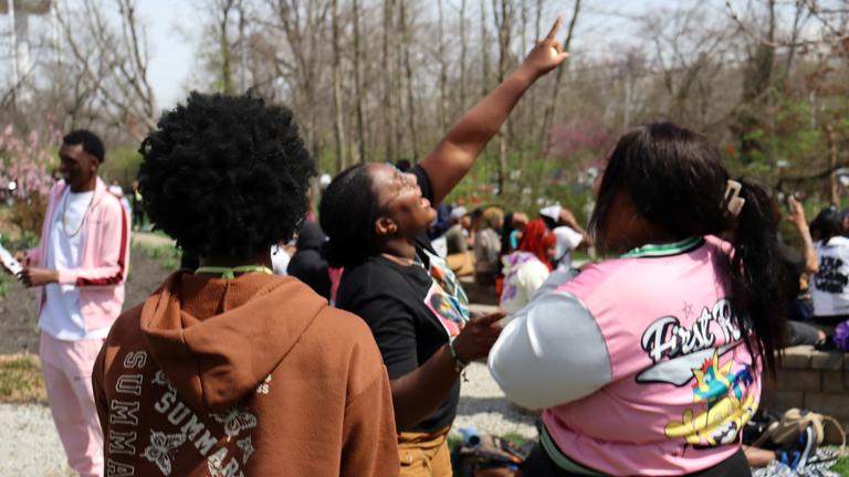 a young person points to the sky during the total solar eclipse