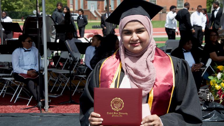 a student holding their diploma
