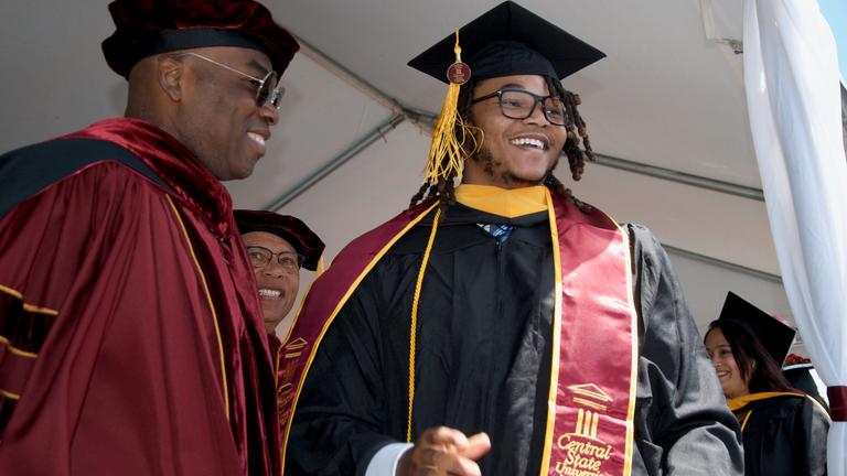 central state university graduate with dr. morakinyo kuti incoming president at central state university on stage at commencement
