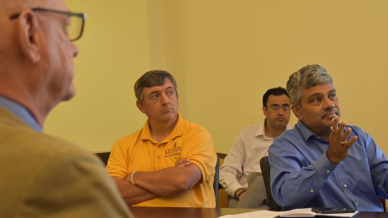 three central state university researchers talk with the governor's senior advisor