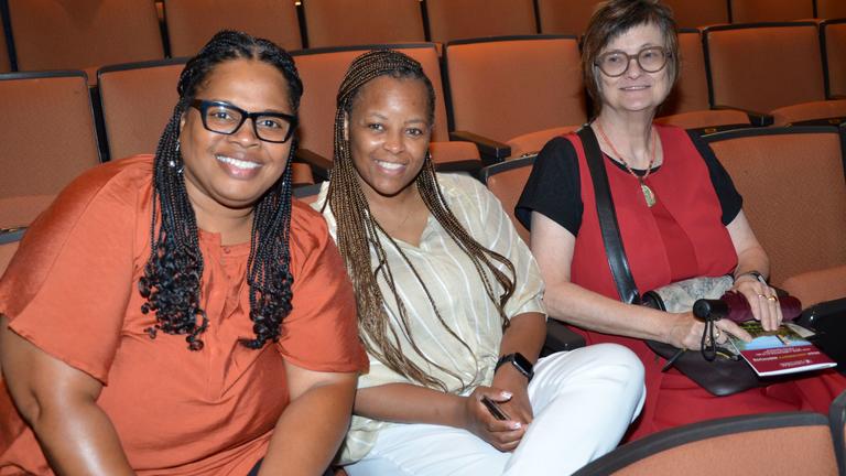 three staff members sit in the paul robeson cultural and performing arts center