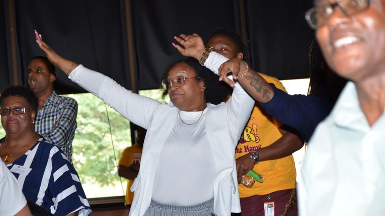 celebrating at university institute with hands in the air