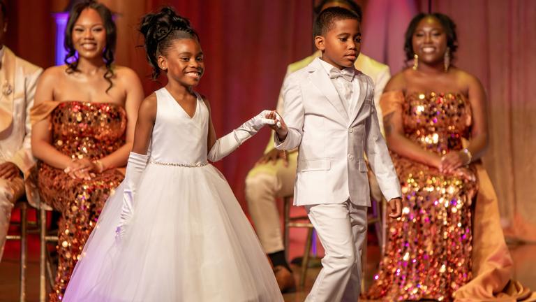 two young children in white fancy dress