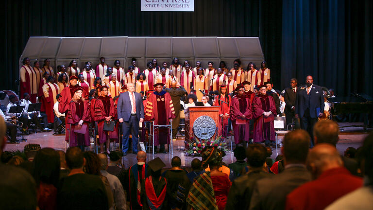 distinguished guests on the stage at the investiture ceremony