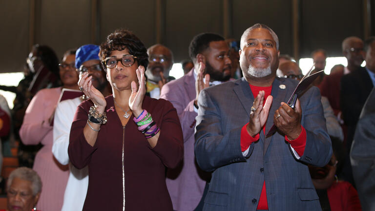 supporters clap during the investiture ceremony