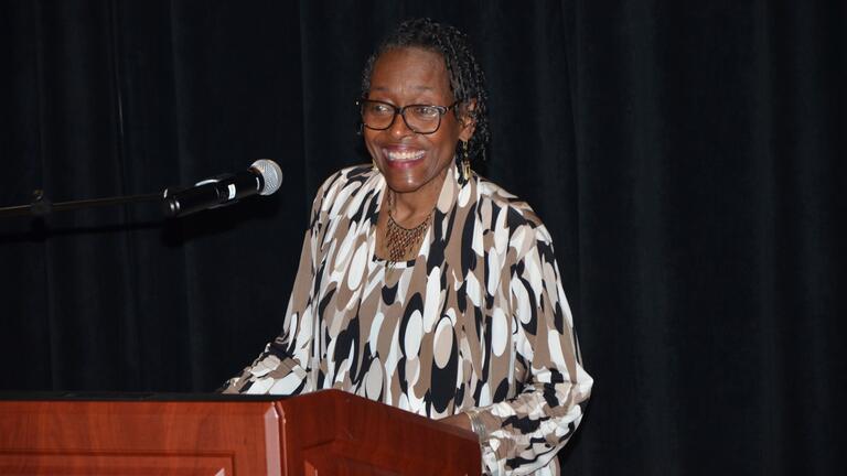 a woman smiles at a podium
