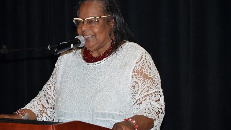 black woman in a white lace blouse