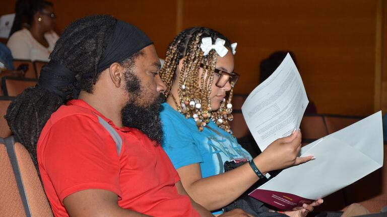 two people look over paperwork in robeson hall