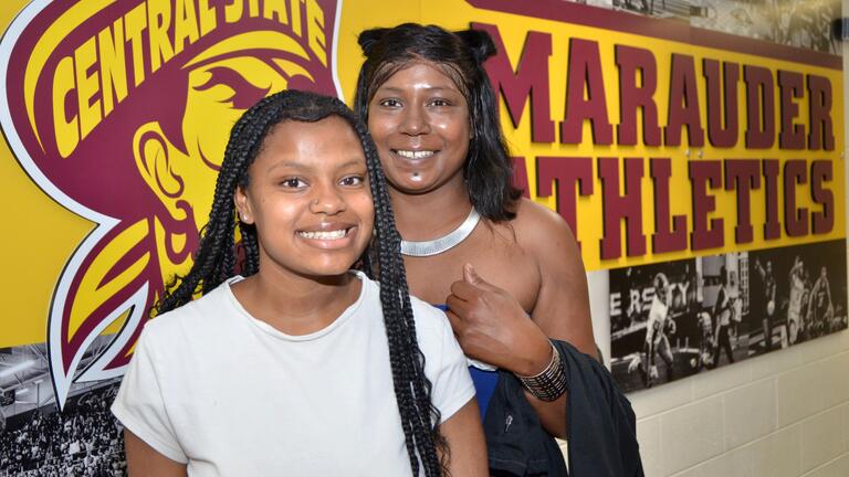 new marauders by an athletics sign in the university student center
