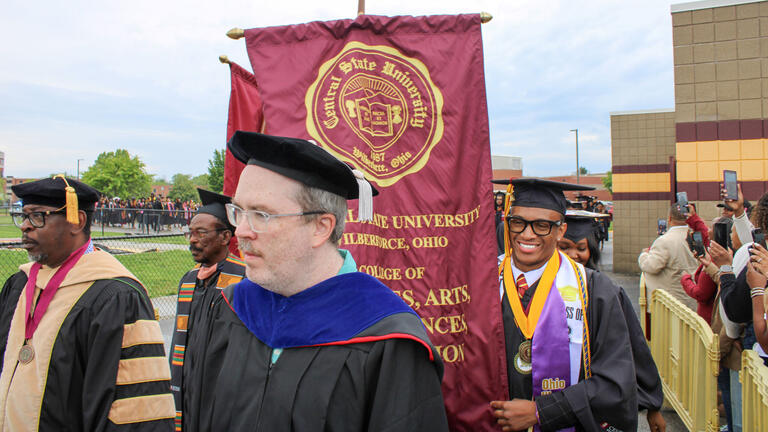 faculty approach the stage