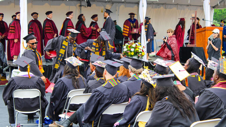 graduates celebrate on stage