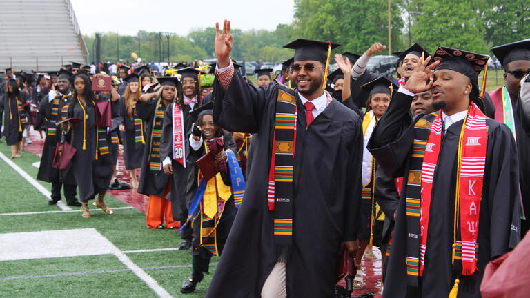 graduates walk in procession