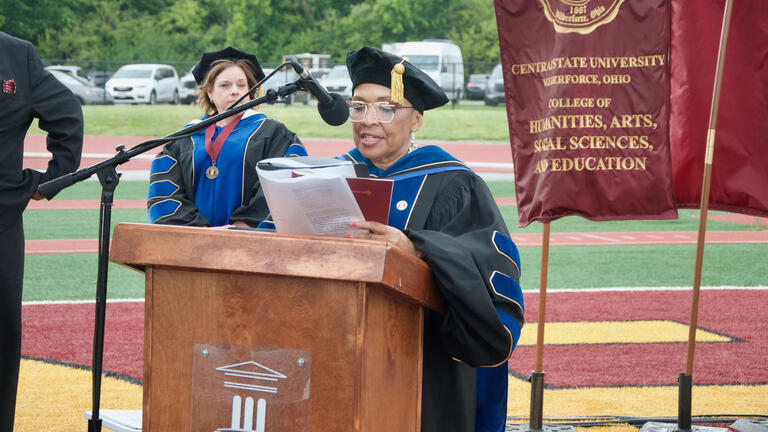 a faculty member speaks at the lecturn