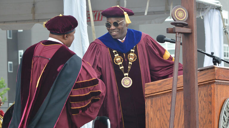 President Kuti stands on stage