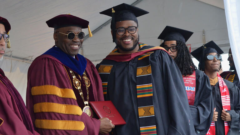 President Kuti stands on stage