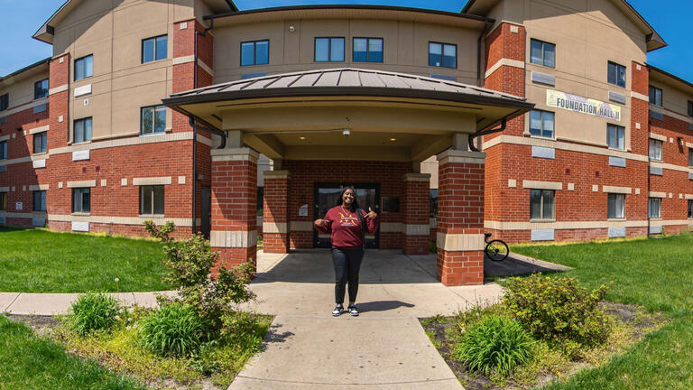 A student stands outside of Foundation Hall