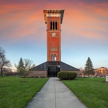 Central State University's historic clock tower is pictured before a pink sunset.