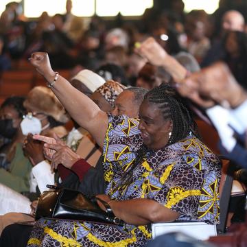 charter day attendees raise their fists in the air while exclaiming, "For God, For Central, For State!"