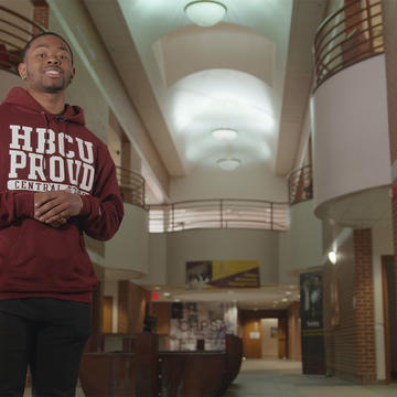 a male student wearing a hoodie that says HBCU Proud in the student center at Central State University
