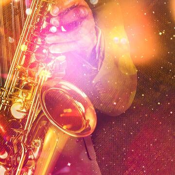 Hands playing a saxophone with a colorful overlay of orange, red, and blue with sparkles