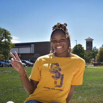 a student wearing a Central State University T-shirt gives a peace sign on the campus in Wilberforce, Ohio