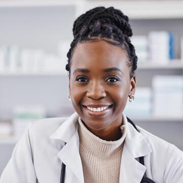 Black woman, doctor and portrait smile in healthcare, pharmacy or medication consultant at clinic. Face of happy African American female medical professional or pharmacist