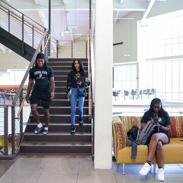Two Students taking the stairs in the student center