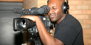 A student shoots video on the Communications Center.