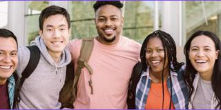 Lined up group of smiling students standing outside