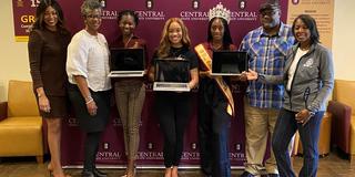 Central State University Vice President of Institutional Advancement Tiffiney Gray and Director of Strategic Partnerships and Corporate Engagement Kim Jones with students accepting laptops donated from the federal reserve banks of cleveland and cincinnati
