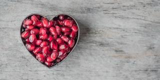 a heart-shaped bowl with cranberries
