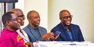 four Black men sit around a table at Central State