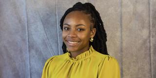 NyAshia Williams Matthews wearing a yellow blouse