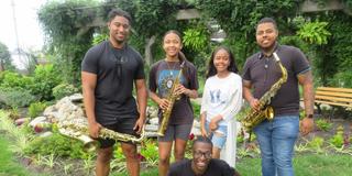 Marvin Harshaw, junior music major; Kamille Austin, senior music major; Corey Higgs, senior music major; Kedron Rolle, senior music major (sitting); and Davaughn Major, 2023 music graduate, presenting jazz in the Seed-to-Bloom Botanical Garden at Central State University