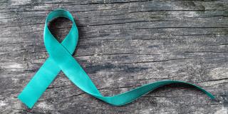 blue sexual assault prevention ribbon on wood