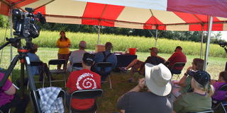 a speaker from Central State University Land-Grant Extension presenting information under a red and white tent at the 61st annual Farm Science Review in London, Ohio