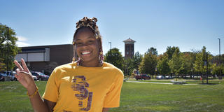 a student wearing a Central State University T-shirt gives a peace sign on the campus in Wilberforce, Ohio