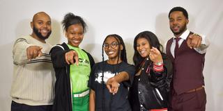 a group of central state university students point at the camera
