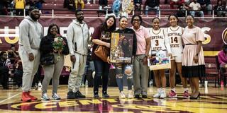 members of the central state university women's basketball team stand together for a photo on the court