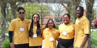 five students wearing nametags and central state university 1890 land-grant polos at the seed to bloom botanical and community garden in wilberforce ohio