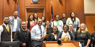 a large group from central state university and officers at montgomery county common pleas court behind a judge's seat