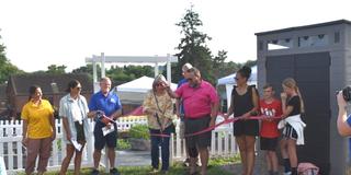 ribbon cutting for brighton grows community garden