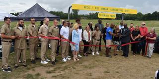 participants in a ribbon-cutting ceremony for an expanded urban farming and teaching program led by central state university extension at richland correctional institution in mansfield ohio