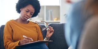 an african american community health worker in a home