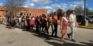 central state university students led by the royal court march to the polls on election day