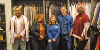 five people stand in front of a wardrobe filled with professional attire in the new Marauder Boutique A Treasure Chest for Success at central state university