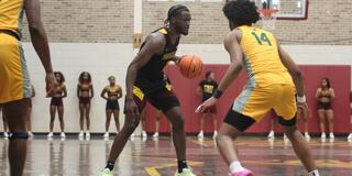 central state university men's basketball player dribbles in front of a kentucky state player
