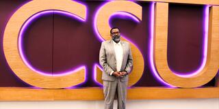 Student Ombudsman Marc DeWitt in front of CSU sign in student center
