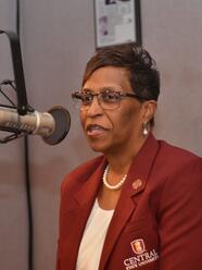 board of trustees chair jacqueline gamblin speaking into a microphone at W C S U