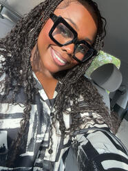 a young african american woman with thick black glasses